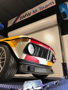 a bmw car is on display in a showroom