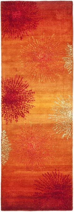 an orange and red rug with trees on it