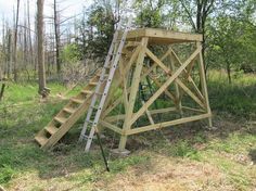 a wooden structure sitting in the middle of a forest