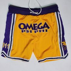 Be summertime-ready in these embroidered Omega Psi Phi shorts. With '1911' and the Omega with bolt featured on the side of each leg, you'll be one of the most stylish Bruhz OWT-side!  Features: -Embroidered Omega with lightning bolt on side of each leg -Notched sides at bottom hem -Drawstring for adjustment capability Throwback Short Bottoms For Sports Events, Throwback Sports Shorts, Collegiate Style Cotton Bottoms For Summer, Summer Collegiate Style Cotton Bottoms, Cotton Shorts For Sports Events, Summer Throwback Style Short Bottoms, Collegiate Cotton Athletic Shorts, Summer Sports Event Bottoms In Short Length, Summer Sports Bottoms With Built-in Shorts