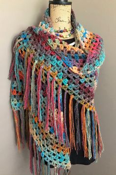 "Crochet Boho Shawl with Fringe. This colorful and stylish Handmade Shawl can be worn confidently for many occasions from casual and fun to totally formal. Made from a soft, premium, acrylic yarn, this piece has the look of brushed wool with the comfort and easy care convenience of acrylic. The yarn is soft, has wonderful texture, and drapes beautifully. The color changes in the yarn are really striking. You can see shades coral, gold, turquoise, mauve and beige throughout.  The classic Crochet Multi Color Crochet, Bridesmaid Wrap, Crocheted Shawl, Beau Crochet, Unique Clothes, Basketweave Stitch, Boho Shawl, شال كروشيه, Crochet Chicken