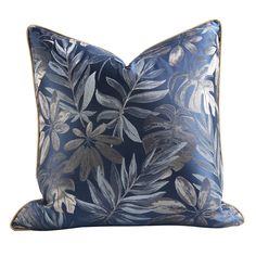 a blue pillow with silver leaves on it