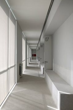 an empty hallway with white walls and doors