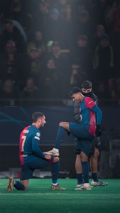 two soccer players sitting on the ground during a game