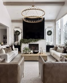 a living room filled with furniture and a flat screen tv mounted to the wall over a fire place