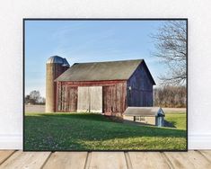 an old barn and silo on a sunny day