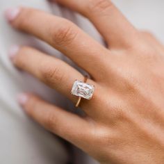 a woman's hand with a diamond ring on it