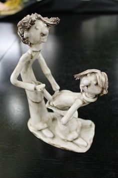 a white figurine sitting on top of a table