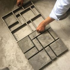 a person that is making some kind of tile