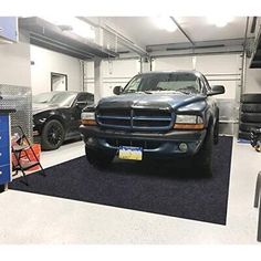 two trucks parked in a garage next to each other