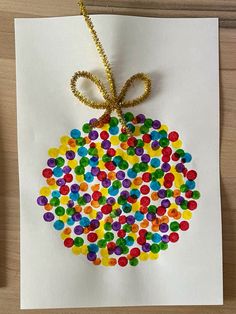 an ornament made out of colored candies on a piece of white paper