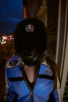 a person wearing a motorcycle helmet and blue jacket