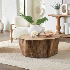 a living room filled with furniture and a large wooden table on top of a rug