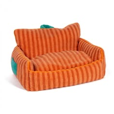 an orange and green striped chair with pillows on it's back legs, sitting in front of a white background