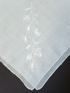 This is a beautiful white handkerchief with a flower embroidered in one corner. Measures 14 inches wide. Condition: This handkerchief is a vintage item so there may be some imperfections. One side of the hem has come a bit loose and there are a few pinprick holes in it from age. See images to get a sense of these flaws. White Floral Embroidery Handkerchiefs For Gift, White Floral Embroidered Handkerchiefs For Gifts, Traditional White Handkerchiefs With Floral Embroidery, White Tonal Embroidery Fabric For Wedding, White Embroidered Border Fabric For Wedding, Formal White Floral Embroidered Fabric, Elegant White Handkerchiefs With Machine Embroidery, Formal White Embroidered Handkerchiefs, Traditional Wedding Handkerchiefs With Embroidered Border