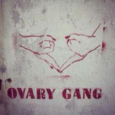 two hands making a heart shape with the words ovary gang painted on it