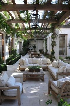 an outdoor living area with couches and tables