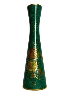 a green vase with yellow flowers painted on it's sides and gold trimmings