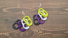 These subtle pride earrings mimic the colors of the non-binary pride flag to give a fun addition to any look, pride based or not! These make a great coming out gift for your teen to add a fun piece of alt jewelry to their collection. The plastic pop tabs are layered from top to bottom yellow, white, purple, and black which gives the earrings a fun sway as you move your head.  Each pre-made plastic charm is approximately 1" long and 0.5" wide, the entire length of the earring is approximately 2.2 Nonbinary Earrings, Non Binary Earrings, Nonbinary Bracelet, Pride Jewelry Earrings, Omnisexual Earrings, Non Binary Pride, Plastic Pop, Soda Tabs, Pop Tabs