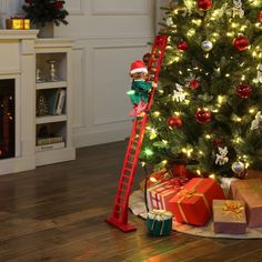 a christmas tree with presents under it and a ladder leading up to the top one