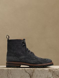 This handsome suede lace-up boot borrows its intricate detailing and wingtip toe from the classic brogue—a testament to its expert Portuguese craftsmanship.  Suede uppers.  Leather lining.  Rubber soles.  Made in Portugal.  Whole and half sizes. Dress Boots Men, Mens Suede Boots, Men's British Style, Mens Dress Boots, Brogue Boots, Rugged Style, Suede Lace, British Style, Suede Boots