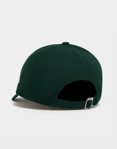 a green hat with a metal buckle on the side