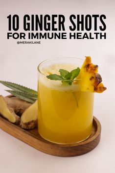 ginger shots for immune health on a wooden tray with mint and pineapple