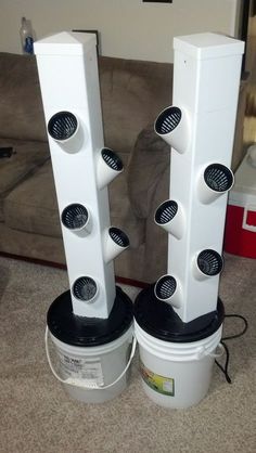 two white speakers sitting next to each other on the floor