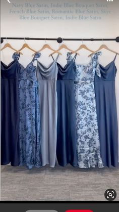 four dresses are hanging on a rack in front of a wall with the words, blue satin