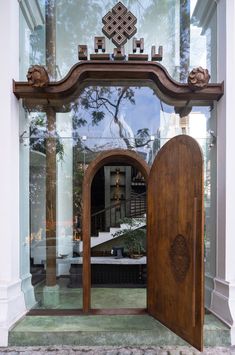 an open wooden door in front of a building