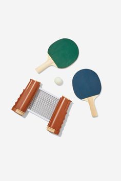 two ping pong paddles and a net on a white background