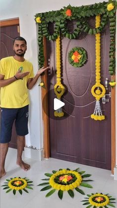 a man standing in front of a door decorated with flowers and garlands on it