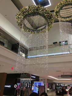 two chandeliers hanging from the ceiling in a shopping mall