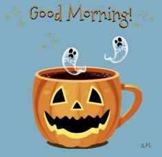 a pumpkin mug with two ghost heads in it and the words good morning on top