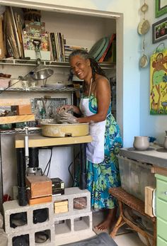 a woman standing in a kitchen preparing food