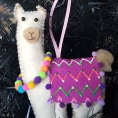 a llama ornament hanging from a christmas tree