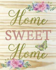 a wooden sign that says home sweet home with pink flowers and green butterflies on it