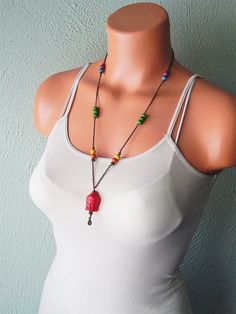 "Buddha necklace - Long beaded rainbow chain necklace - chakra necklace - bohemian jewelry - festival necklace - good karma - lucky buddha - Part of my Good Karma collection - This piece features a large red carved stone buddha head I've embellished with a small brass pendulum drop. The buddha is suspended from a hand beaded chain I have created with rainbow colored stone beads. This necklace measures 25 inches, and the pendant dangles down an additional 2 1/4inches. It secures with a lobster cl Spiritual Necklaces With Dangling Beads, Bohemian Rainbow Necklace For Festivals, Spiritual Festival Necklaces With Dangling Beads, Rainbow Beaded Chain Necklace For Festivals, Bohemian Beaded Pendant Necklace With Adjustable Chain, Rainbow Bohemian Jewelry For Festivals, Spiritual Charm Necklaces For Festivals, Bohemian Rainbow Jewelry For Festivals, Festival Crystal Necklace With Beaded Chain