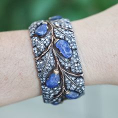 Vintage Buccellati 18k gold and silver cuff bracelet, set with carved sapphires and rose cut diamonds. DESIGNER: Buccellati MATERIAL: 18k Yellow Gold / Silver GEMSTONES: Diamond, Sapphire DIMENSIONS: Bracelet will fit approx. 6.75" wrist and is 30mm wide. MARKED/TESTED: Buccellati. WEIGHT: 69 grams CONDITION: Previously Owned / Excellent Condition Gold Bracelet Cuff, Diamond Gold, Silver Cuff Bracelet, Rose Cut Diamond, Silver Cuff, Sapphire Diamond, Selling Jewelry, Estate Jewelry, Gold And Silver