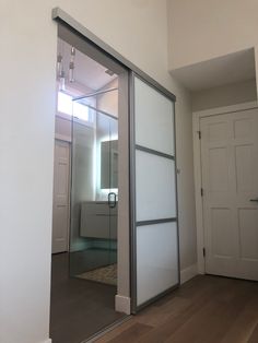 an empty room with sliding glass doors on the wall and wood flooring in front of it