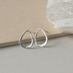 These minimalist studs are a stylish jewelry staple. They're made of sterling silver wire in an elegant teardrop shape and I've hammered it for texture and shine. The studs are 15mm long and about 12mm at their widest making them a perfect size for every day wear. I've soldered sterling silver posts to the tops of them and they are held securely in place with sterling silver backings. The earrings are very lightweight and comfortable to wear and the simple design makes them a versatile accessory Minimalist Hypoallergenic Teardrop Jewelry, Hypoallergenic Minimalist Teardrop Jewelry, Minimalist Nickel-free Teardrop Earrings For Everyday, Minimalist Hammered Drop Earrings, Minimalist Teardrop Drop Earrings As Gift, Minimalist Sterling Silver Drop Earrings For Everyday, Silver Pear-shaped Dainty Earrings, Everyday Nickel-free Minimalist Teardrop Earrings, Dainty Pear-shaped Silver Earrings