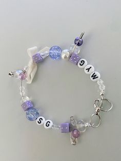 a bracelet with beads and charms that say we are 5 / 6 on the front