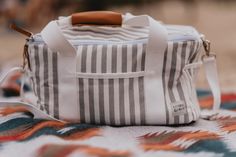 Whether you're heading out for a day at the beach, a picnic in the park or a BBQ in your backyard, enjoying an ice-cold beverage on a hot day is an absolute must. Our premium insulated cooler and food warmer bags are here to perfect your ultimate all-day Summer set up, keeping your food and drinks cold and crisp, from sunrise to sunset. This bag can be used for takeout food, potluck food carrier, casserole dish carrier, family style picnic basket bag, hiking food storage bag and many more!  This Casual White Lunch Bag For Travel, Rectangular Lunch Bag For Summer Outdoor, Rectangular White Lunch Bag For Travel, Rectangular Summer Outdoor Lunch Bag, White Reusable Travel Bags, White Tote Bag For Outdoor Activities, White Large Capacity Bag For Picnic, Large Capacity Rectangular Lunch Bag For Picnic, White Reusable Beach Bag For Travel