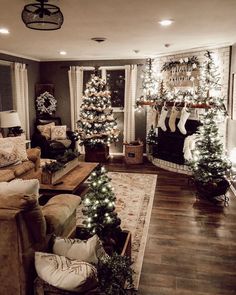 the living room is decorated for christmas with stockings and garlands on the fireplace mantel