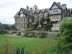 a large building with many windows and lots of greenery