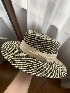 The wide brim of the hat provides excellent sun protection, shielding your face and neck from harmful UV rays. Whether you're lounging at the beach, attending a garden party, or strolling through a bustling market, this hat offers the perfect balance between style and practicality. The elegant white ribbon band adds a touch of sophistication and can be adjusted to ensure a snug fit, accommodating various head sizes. The timeless design of this straw hat makes it a versatile accessory that comple Lightweight Flat Brim Straw Hat For Sunbathing, Cream Short Brim Panama Hat For Vacation, Cream Panama Hat With Short Brim For Vacation, Woven Straw Panama Hat With Flat Brim, Beige Straw Beach Hat, Casual Toquilla Straw Sun Hat For Sunbathing, Cream Wide Brim Straw Fedora, Flat Brim Straw Hat For Picnic, Spring Coastal Boater Hat In Straw