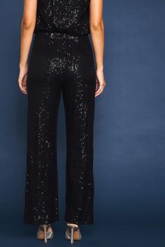 These occasion-ready pants are adorned with shimmering sequins, creating a look that's impossible to miss. The silhouette is defined by a high-rise waist and slightly flared legs. A foolproof piece that's sure to command attention wherever you go. •High waist •Slightly flared silhouette •Hidden side zip Black Sequin Pants Outfit, Sequins Pants Outfit, Black Sequin Pants, Maxi Jumpsuit, Sequin Pants, Swimwear Sets, Flared Pants, Long Sleeve Midi, Skirt Leggings