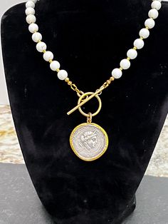 This is a necklace made by me using a romantic replica of an Ancient Greek coin. The chain is made with a zinc and nickel free gold alloy metal and is offered in 3 lengths.  Thank you for looking! White Coin Pendant Necklace As A Gift, White Coin Pendant Necklace For Gift, White Coin Pendant Necklace, White Coin Pendant Jewelry, White Round Coin Pendant Necklace, White Medallion Necklace With Coin Pendant, White Coin Pendant Jewelry As Gift, White Medallion Coin Pendant Necklace, White Coin Pendant Jewelry For Gift