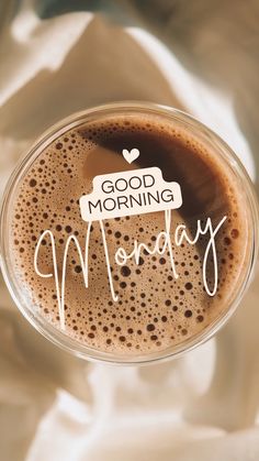 a cup of coffee with the words good morning monday written on it in cursive writing