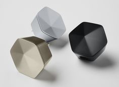 three different colored knobs sitting next to each other on a white surface with no one around them